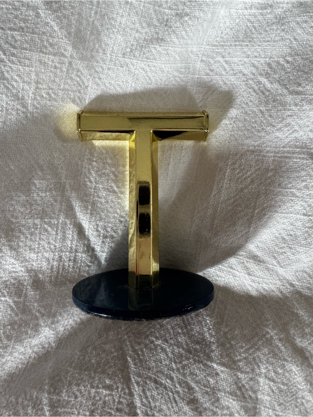 Umbra Gold T-Shaped Jewelry Stand on Navy Base